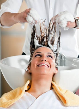 Woman getting her hair shampooed